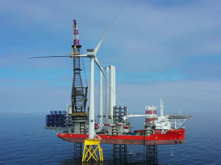 Offshore wind turbine being installed using giant crane