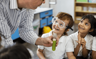 Teacher with school children holding a test tube