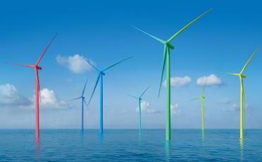Mult-coloured offshore wind turbines in the sea