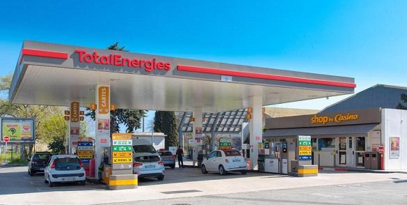 Exterior of a service station forecourt with TotalEnergies sign in red letters